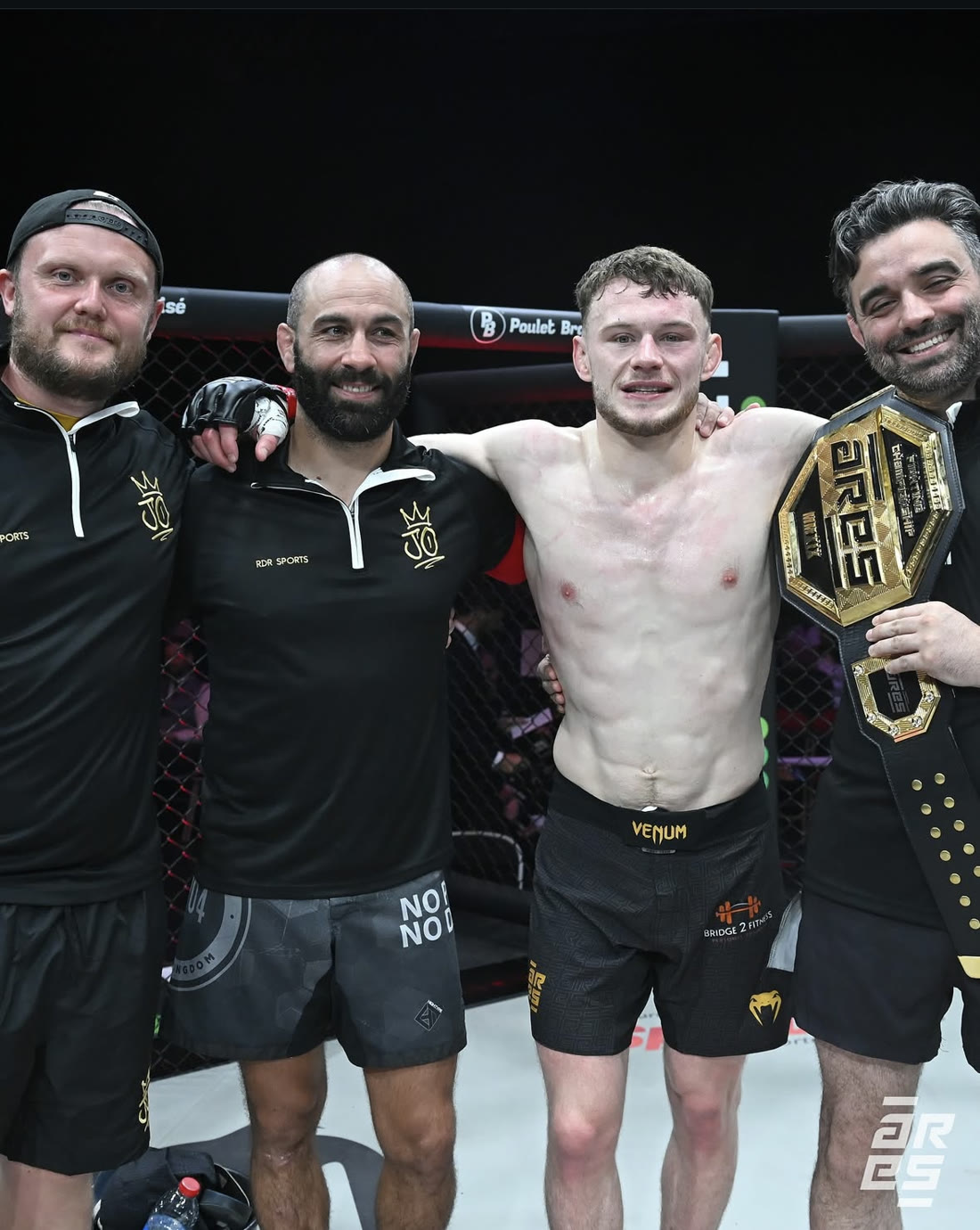 Josh O’Connor and three members of his coaching team together in the ARES cage after defending the title